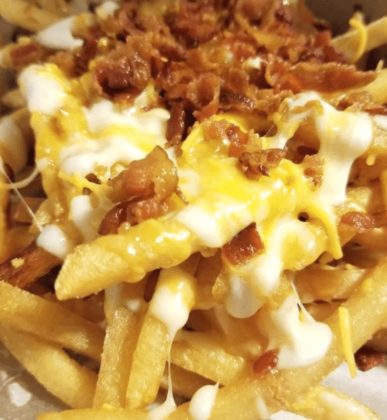 Loaded bacon cheese fries with melted cheese sauce