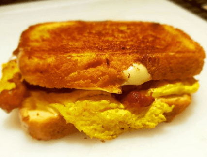 Simple bacon, egg and cheese breakfast sandwich on toasted bread