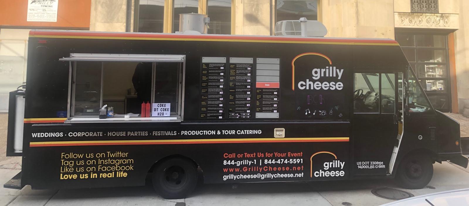 Grilly Cheese food truck catering at an outdoor event with guests enjoying grilled cheese sandwiches