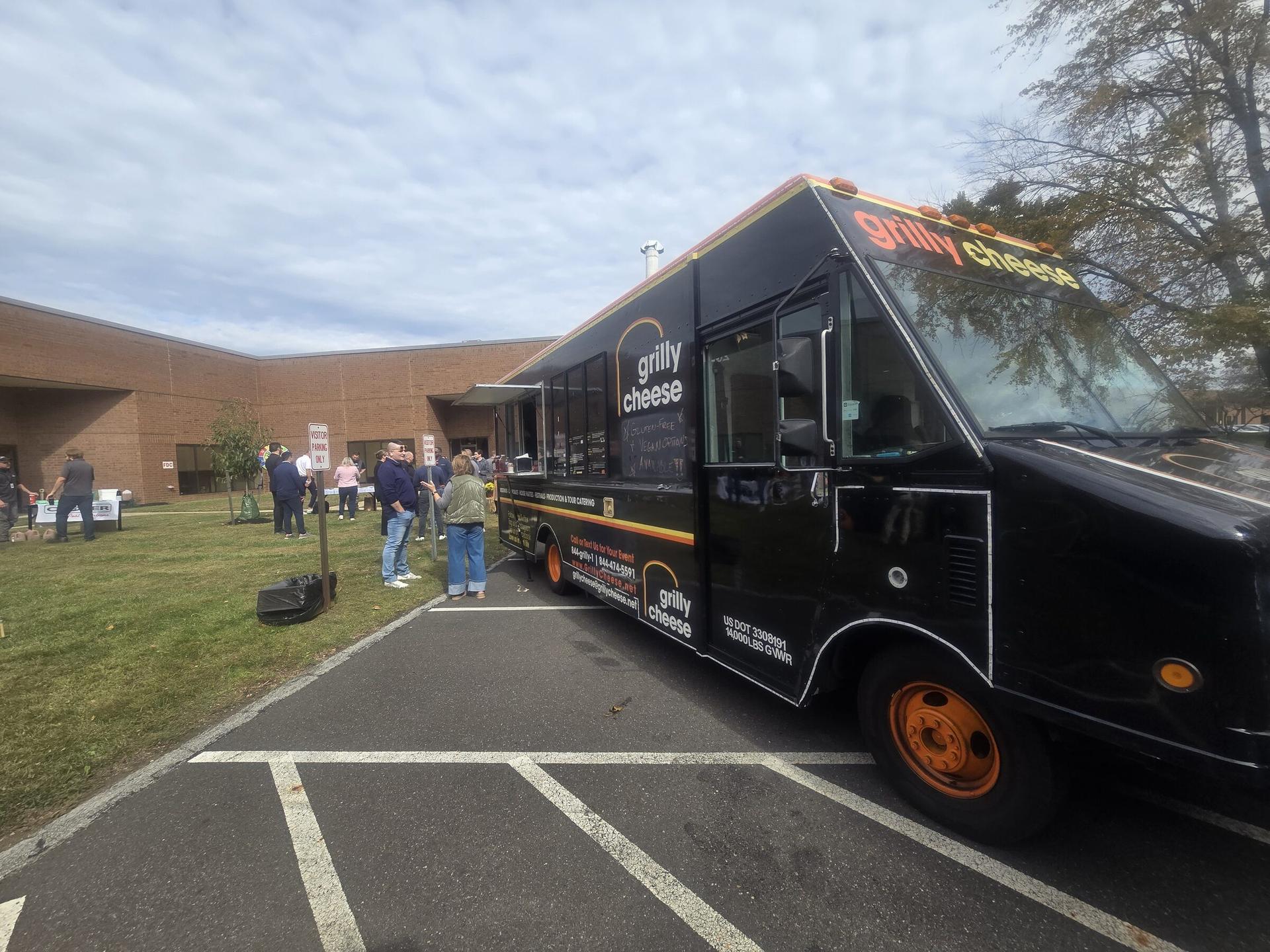 The Grilly Cheese food truck parked outside an event venue